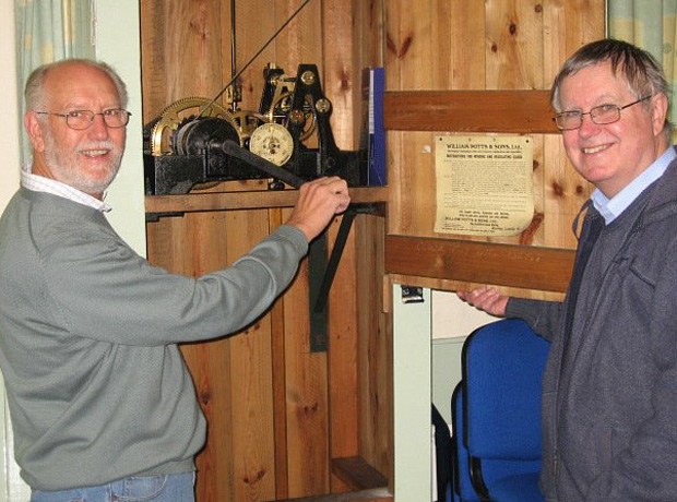 Peter Nattrass, left, and David Heatherington at the control point for the clock inside the hall